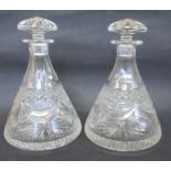 A pair of conical shaped glass decanters and stoppers, height 9.75ins