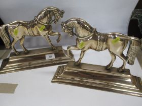 A pair of Brass horse door stops