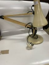 A cream angle poise lamp