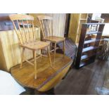 A set of shelves, bureau, oak dining table and two chairs