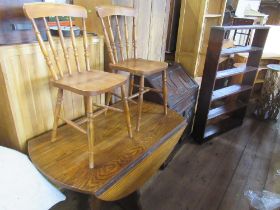 A set of shelves, bureau, oak dining table and two chairs
