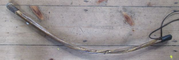 An African throwing stick, of curved form, length 27ins