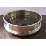 A silver wine coaster, with turned wooden base, diameter 5ins
