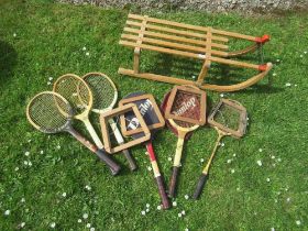 A vintage sledge and a collection of tennis rackets