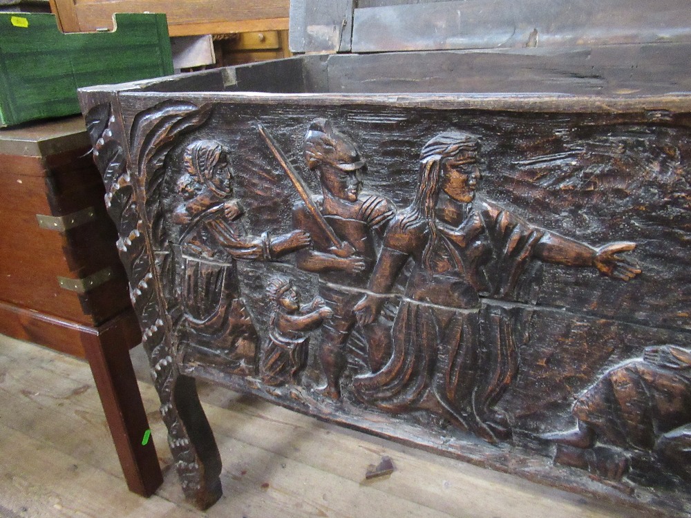 An antique oak coffer with plain raising lid the sides having fielded panels with carved decoration, - Image 5 of 5