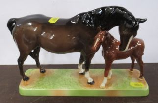 A Beswick model, bay mare and foal, on rectangular base, height 6.5ins
