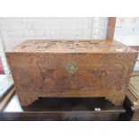 An oriental design coffer with relief decoration width 29ins  height 16ins