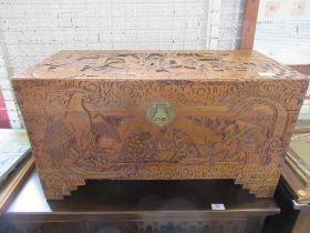 An oriental design coffer with relief decoration width 29ins  height 16ins