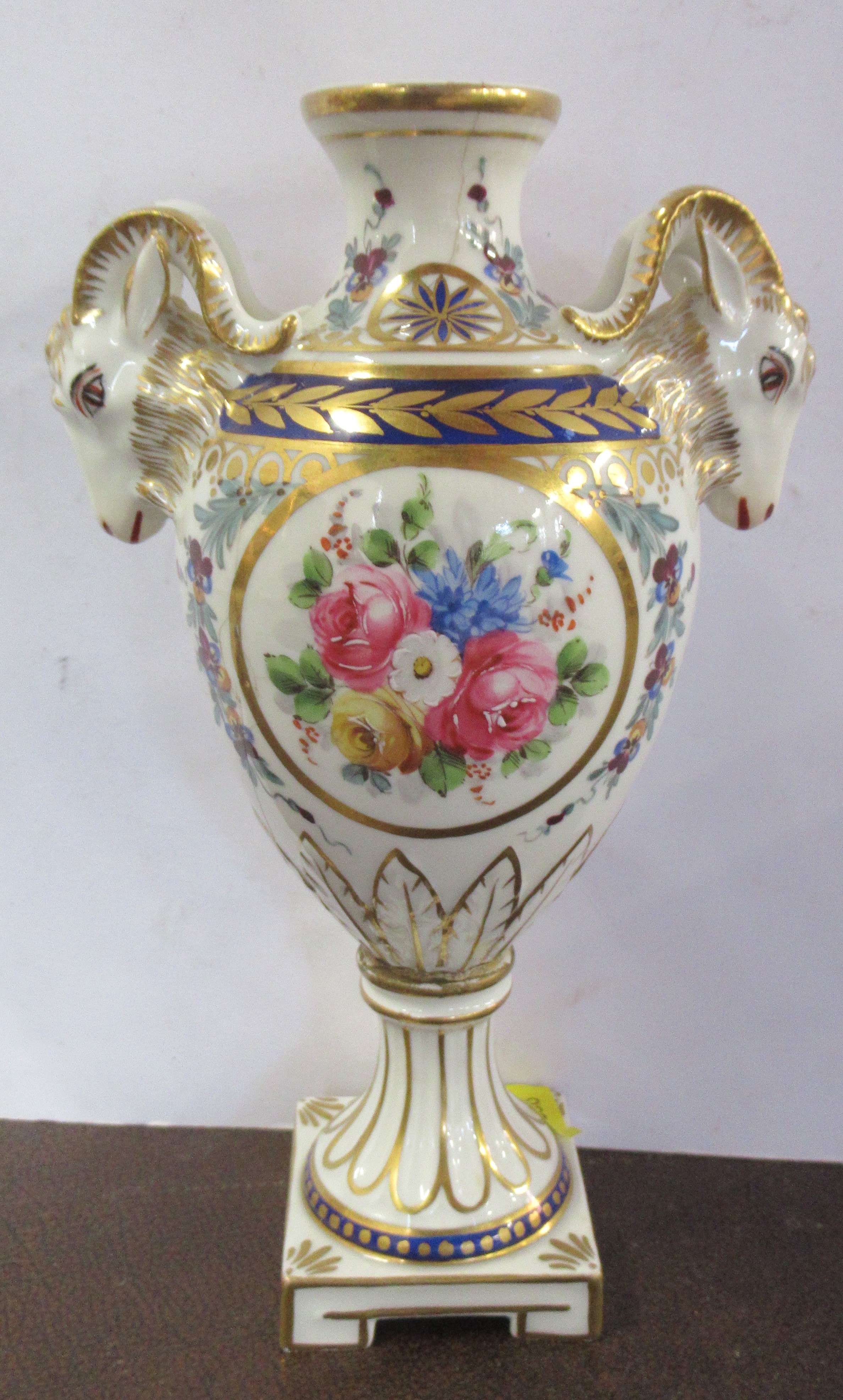A 19th century Sevres porcelain pedestal vase, decorated with rams masks and flowers, af, height 7.
