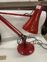 A red angle poise lamp