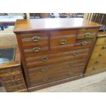 An Edwardian mahogany chest of drawers having central drawer flanked by two smaller drawers over