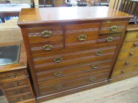 An Edwardian mahogany chest of drawers having central drawer flanked by two smaller drawers over