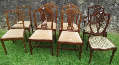 A collection of dining chairs, including four single dining chairs, decorated with a wheatsheaf