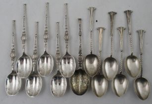 A set of six silver anointing tea spoons, together with another silver anointing spoon and a set