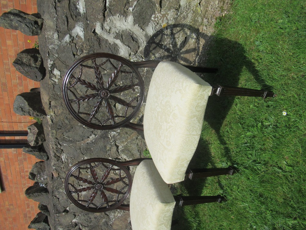 A set of four 18th/19th century mahogany dining chairs, in the Hepplewhite style,  with circular - Image 2 of 3