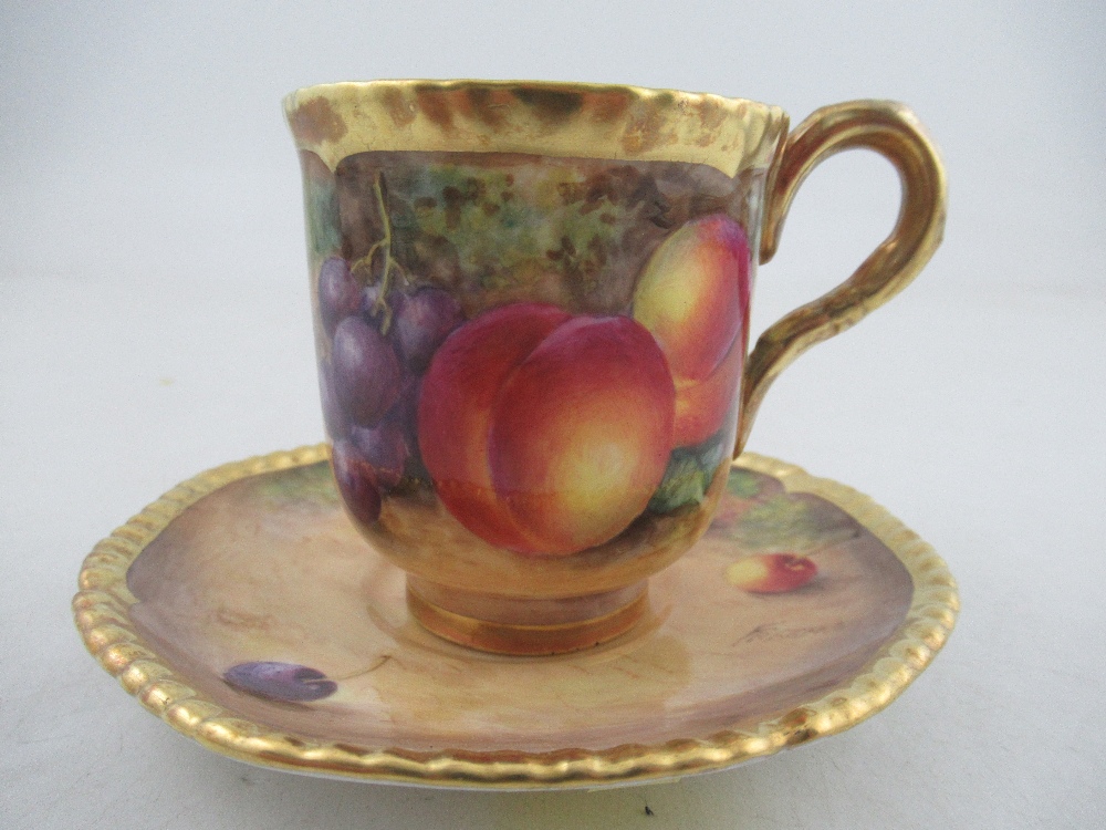 A Royal Worcester coffee cup and saucer decorated with fruit by Freeman  Condition Report: Good