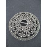 A circular silver pierced brooch, marked 800, diameter 2ins