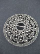 A circular silver pierced brooch, marked 800, diameter 2ins