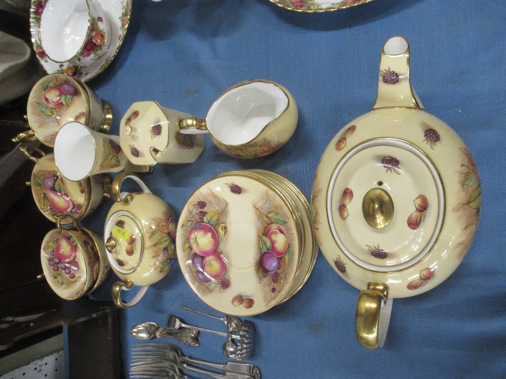A collection of Aynsley tea ware decorated with fruit to include tea pot, sugar bowl etc