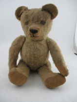 An early to mid 20th century plush jointed teddy bear, with growler (not working)