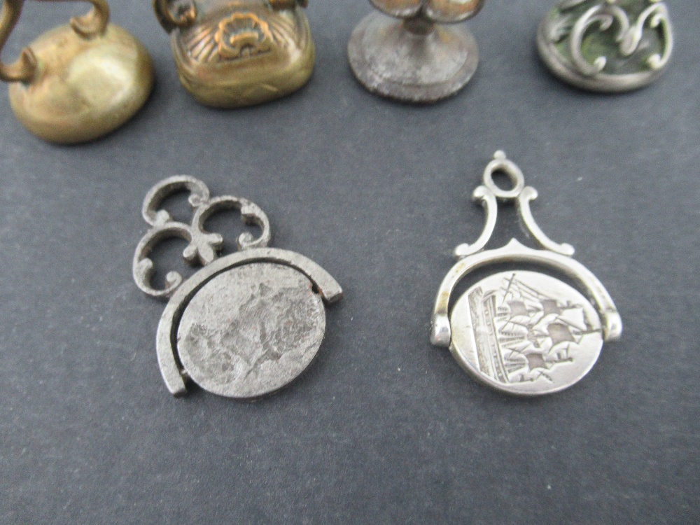 A group of Georgian and later desk seals, two with swivel action, one engraved with a ship, the - Image 2 of 4