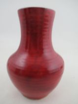 A Moorcroft Pottery vase, decorated with a red Flambe glaze, height 7.25ins Condition Report: