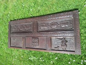 An Antique oak carved panel, with fielded panels  decorated with figure and crest, dated 1633, width