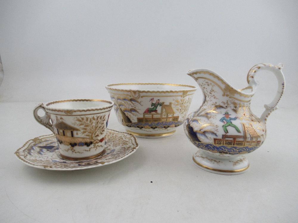 A Chamberlains Worcester tea cup and saucer, slop bowl and milk jug all decorated with the acrobat