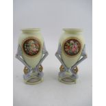 A pair of Grainger Worcester vases decorated with urns with reserved panels of flowers supported
