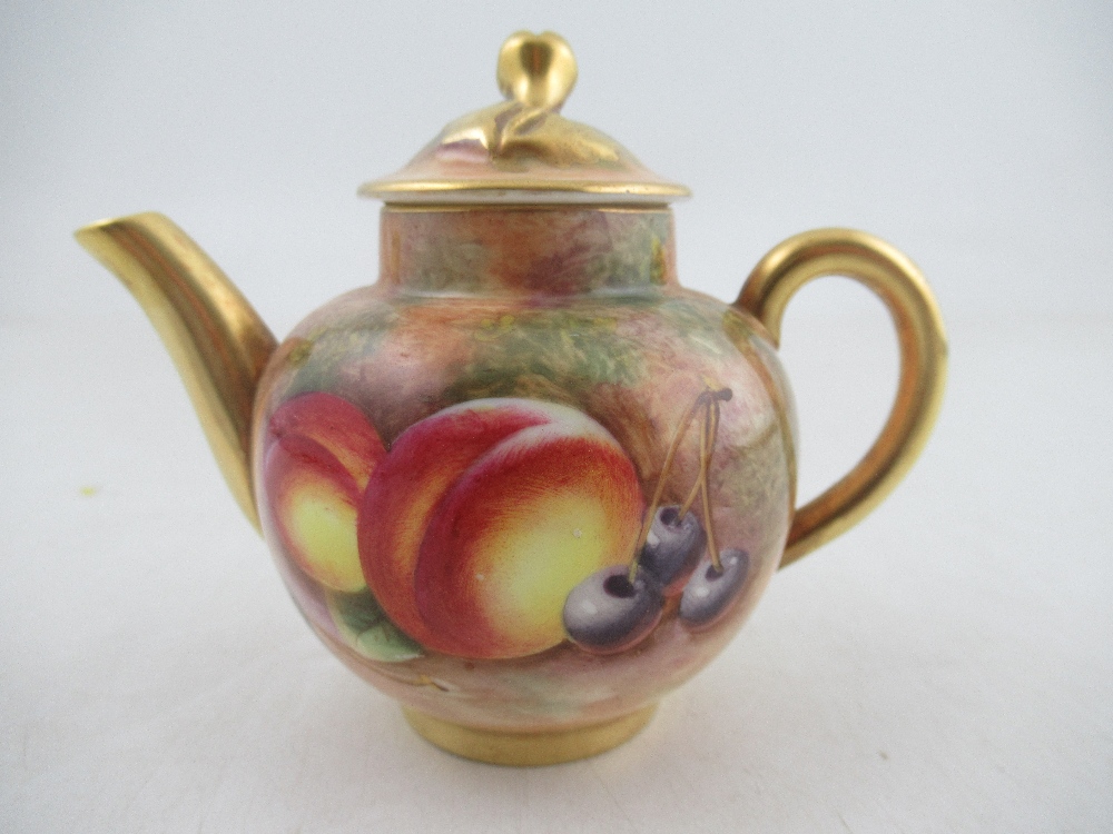 A Royal Worcester miniature tea pot by Roberts height 3.25ins  Condition Report: Good condition,