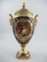 A large Coalport vase decorated with blue and ivory gilded ground reserving a fruit panel of