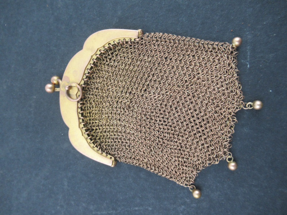 A 9ct gold mounted small mush Purse, the mount cast floral scrolls , stamped 9ct with pendant gold