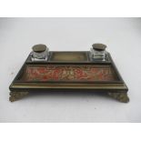 A Boulle work desk stand, with brass decoration, fitted with two brass topped glass ink