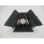 A novelty silver plated desk clock, formed as a cricket ball, stumps, bails and bats, on plinth