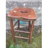 A mahogany bar stool with shaped seat, raised on turned legs united by stretchers