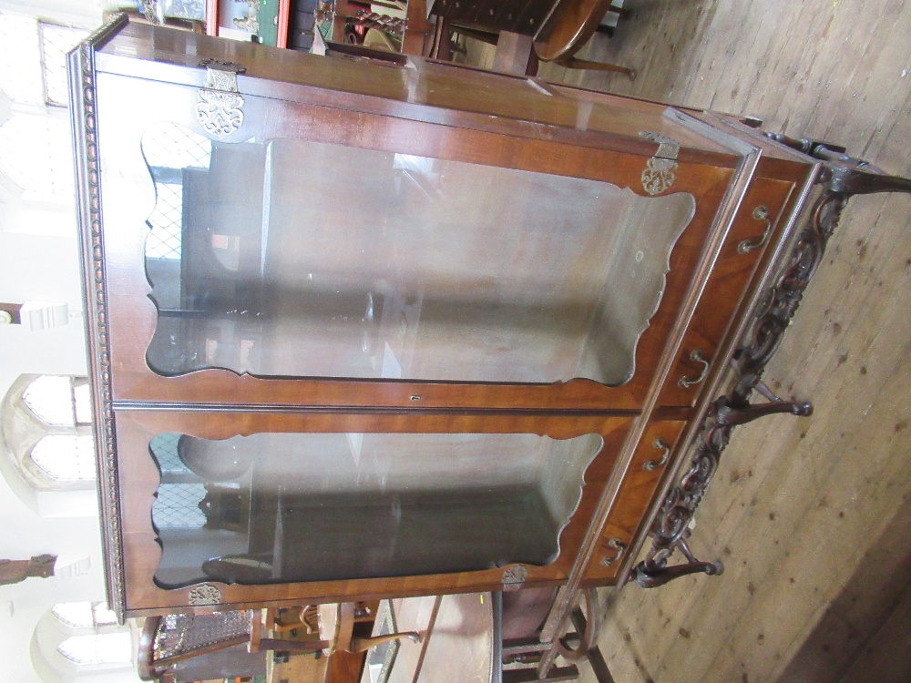 A walnut display cabinet on stand,  with glass shelves, width 52ins, height 69ins