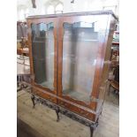 A walnut display cabinet on stand,  with glass shelves, width 52ins, height 69ins