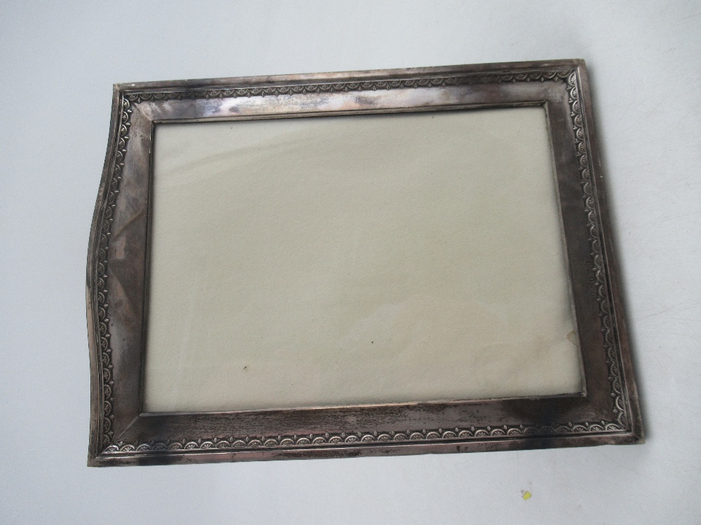 A silver mounted photograph frame, of rectangular form, with embossed decoration, the velvet lined