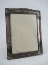 A silver mounted photograph frame, of rectangular form, with embossed decoration, the velvet lined