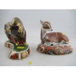 A Royal Crown Derby paperweight of a seated fawn and a standing bull