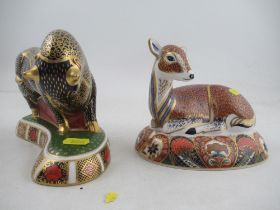 A Royal Crown Derby paperweight of a seated fawn and a standing bull