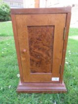 An Arts and Crafts oak and burr wood table top cabinet, width 9ins, height 16.5ins