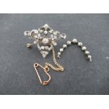 A Victorian diamond silver on gold open work Brooch/Pendant with central old cut diamonds estimate