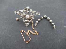 A Victorian diamond silver on gold open work Brooch/Pendant with central old cut diamonds estimate