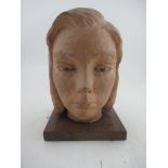 A 20th century terracotta bust, of a young woman, on wooden base, height, 10.5ins