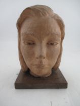 A 20th century terracotta bust, of a young woman, on wooden base, height, 10.5ins