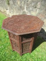 An Eastern design carved  occasional table, with octagonal top, width 24ins, height 25ins