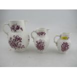 A set of three graduated Royal Worcester jugs decorated with purple flowers to a white ground