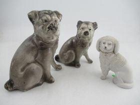 Three porcelain models, of seated dogs, two of pug type dogs, the other of a Staffordshire style
