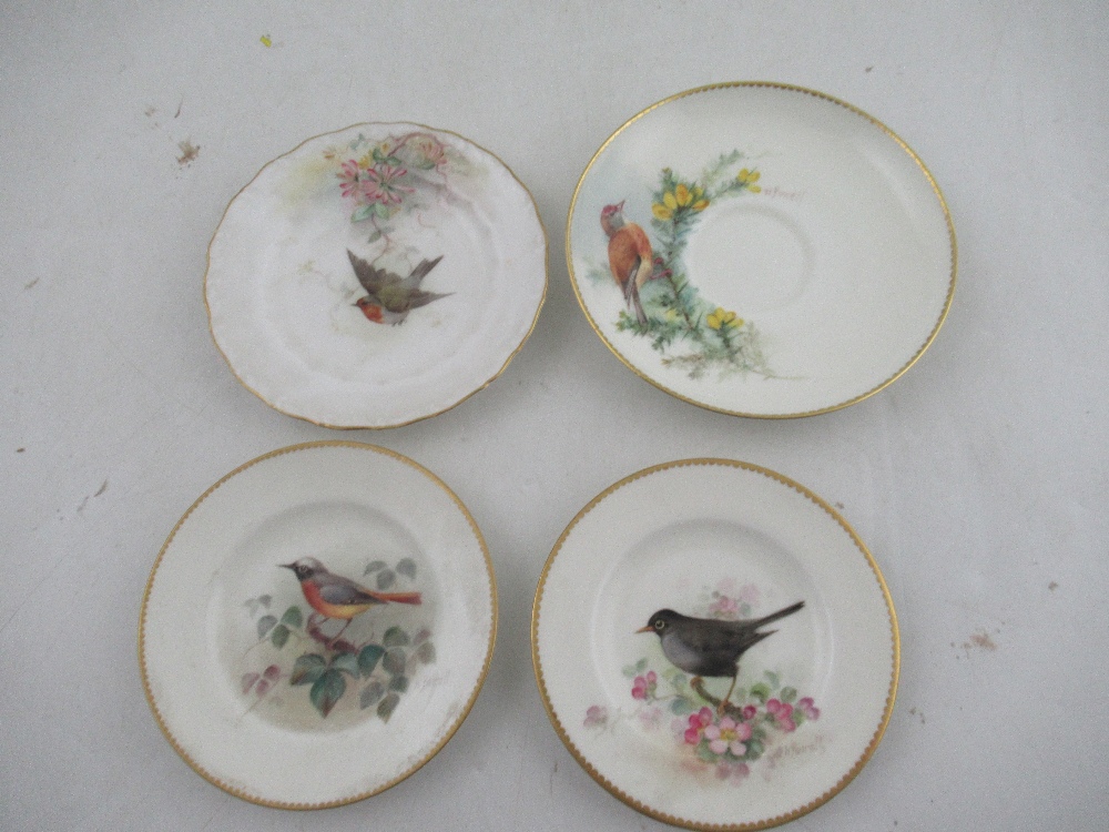 Two Royal Worcester miniature plates decorated with a Red Start, Black bird, Robin and a Linnet by